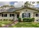 Attractive home exterior with a well-kept lawn, symmetrical landscaping, and dark shutters complementing the neutral paint at 1466 Normandy Park Dr # 4, Clearwater, FL 33756
