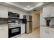 Bright kitchen with stainless steel appliances, white cabinets, granite countertops, and modern subway tile at 1466 Normandy Park Dr # 4, Clearwater, FL 33756