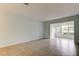 Spacious living room with tile flooring and a sliding glass door leading to an outdoor patio at 1466 Normandy Park Dr # 4, Clearwater, FL 33756