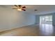A view of the bright living room with a ceiling fan and tile flooring, perfect for entertaining or relaxing at 1466 Normandy Park Dr # 4, Clearwater, FL 33756