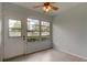 Bright room with tile flooring, ceiling fan, and natural light from the large window and door at 1466 Normandy Park Dr # 4, Clearwater, FL 33756