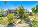 Beautiful backyard featuring lush greenery, and a covered outdoor kitchen at 151 Harrisburg St, Port Charlotte, FL 33954