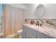 Updated bathroom featuring granite countertop, modern fixtures, and decorative mirror at 151 Harrisburg St, Port Charlotte, FL 33954