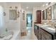 Bright bathroom with a soaking tub, walk-in closet, and double vanity with granite countertop at 151 Harrisburg St, Port Charlotte, FL 33954