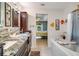 Bathroom featuring a double vanity, soaking tub, and elegant fixtures at 151 Harrisburg St, Port Charlotte, FL 33954