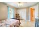 Bedroom with natural light, blue curtains, and a view into the next room at 151 Harrisburg St, Port Charlotte, FL 33954