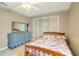 Cozy bedroom with a wooden bed frame, matching dresser, and ceiling fan at 151 Harrisburg St, Port Charlotte, FL 33954