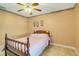 Bedroom with ceiling fan, tiled floors, natural light and warm color palette at 151 Harrisburg St, Port Charlotte, FL 33954
