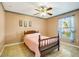 Bedroom with ceiling fan, tiled floors, natural light and warm color palette at 151 Harrisburg St, Port Charlotte, FL 33954