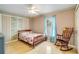 Bedroom with tiled floors, ceiling fan, rocking chair and wooden bed frame at 151 Harrisburg St, Port Charlotte, FL 33954