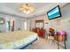 Bedroom with ceiling fan and adjacent bathroom, creating a peaceful, private retreat at 151 Harrisburg St, Port Charlotte, FL 33954