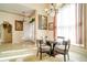 Bright dining area with a glass table, chandelier, and large windows at 151 Harrisburg St, Port Charlotte, FL 33954