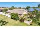 Beautiful backyard with lush landscaping, a fenced yard, and colorful flowers at 151 Harrisburg St, Port Charlotte, FL 33954