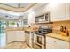Kitchen featuring granite countertops, stainless steel appliances, and ample storage at 151 Harrisburg St, Port Charlotte, FL 33954