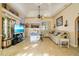 Spacious living room with tile floors, ceiling fan and sliding glass doors to the pool at 151 Harrisburg St, Port Charlotte, FL 33954