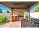 Outdoor kitchen under a covered patio featuring a grill, storage, and cooking space at 151 Harrisburg St, Port Charlotte, FL 33954