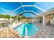 Screened-in swimming pool area with beautiful tile and stone accents at 151 Harrisburg St, Port Charlotte, FL 33954