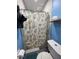 Cozy bathroom featuring blue walls and a seashell-themed shower curtain at 1571 Belleair Rd, Clearwater, FL 33756