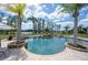 Beautiful backyard pool surrounded by palm trees and overlooking the lake at 17221 Breeders Cup Dr, Odessa, FL 33556