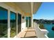 Lovely balcony view with sliding glass doors, a decorative light, and view of the waterfront and clear blue sky at 1860 N Fort Harrison Ave # 301, Clearwater, FL 33755