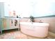 Elegant bathroom featuring a freestanding tub, vanity with a decorative front and modern finishes at 1860 N Fort Harrison Ave # 301, Clearwater, FL 33755