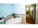 Elegant bathroom featuring a soaking tub, stylish vanity, and modern fixtures with sleek mirror at 1860 N Fort Harrison Ave # 301, Clearwater, FL 33755