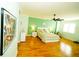 Bright bedroom with wood floors, ceiling fan, and a chair by the window at 1860 N Fort Harrison Ave # 301, Clearwater, FL 33755