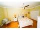 Cozy bedroom featuring a ceiling fan, wood floors, and nautical-themed bedding at 1860 N Fort Harrison Ave # 301, Clearwater, FL 33755
