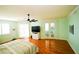 Light and airy bedroom with hardwood floors, ceiling fan, and decorative glass doors at 1860 N Fort Harrison Ave # 301, Clearwater, FL 33755