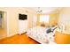 Bedroom with hard wood floors, ceiling fan, and TV atop a dresser at 1860 N Fort Harrison Ave # 301, Clearwater, FL 33755