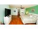 Spacious bedroom with wood floors, ceiling fan, and ensuite bathroom at 1860 N Fort Harrison Ave # 301, Clearwater, FL 33755