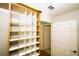 Custom designed walk-in closet with cubbies and open access to a door at 1860 N Fort Harrison Ave # 301, Clearwater, FL 33755