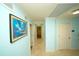 Hallway with travertine floors and neutral wall colors and bright lighting at 1860 N Fort Harrison Ave # 301, Clearwater, FL 33755