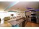 Modern kitchen with stainless steel appliances and granite countertops open to the living room at 1860 N Fort Harrison Ave # 301, Clearwater, FL 33755