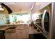 Modern kitchen with stainless steel appliances and granite countertops overlooking the living area at 1860 N Fort Harrison Ave # 301, Clearwater, FL 33755