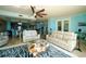 Beautiful open-concept living room with ocean views, ceiling fan and modern white furnishings at 1860 N Fort Harrison Ave # 301, Clearwater, FL 33755