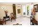 Condo lobby area with marble tile floors, decorative vases, vintage furniture, and an elevator access at 1860 N Fort Harrison Ave # 301, Clearwater, FL 33755