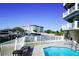 Inviting pool area with comfortable lounge chairs and views of the waterway and docked boats at 1860 N Fort Harrison Ave # 301, Clearwater, FL 33755