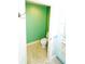 Small powder room featuring bright green walls and a tiled floor at 1860 N Fort Harrison Ave # 301, Clearwater, FL 33755