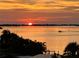 Beautiful sunset view over the water featuring stunning colors and a boat creating a serene backdrop at 1860 N Fort Harrison Ave # 301, Clearwater, FL 33755
