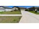 Home featuring a well-manicured lawn, driveway, and charming curb appeal at 18715 Alfaro Loop Ct, Spring Hill, FL 34610