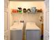 Neat laundry closet featuring a washer and dryer, with ample storage at 18715 Alfaro Loop Ct, Spring Hill, FL 34610