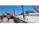 Beach scene featuring sand sculptures, tents, people, and buildings in the background, sunny skies above at 2047 Indigo Dr, Clearwater, FL 33763