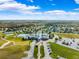 Aerial view of community amenities, including a pool, clubhouse, tennis courts, and well-maintained grounds at 22229 Storybook Cabin Way, Land O Lakes, FL 34637