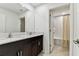 Dual sink vanity bathroom with a view into the bright shower and tub with white subway tile at 22229 Storybook Cabin Way, Land O Lakes, FL 34637