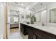Elegant bathroom with dual sinks, white countertops, and a shower offers a refreshing and modern aesthetic at 22229 Storybook Cabin Way, Land O Lakes, FL 34637