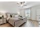 Well-lit bedroom features ceiling fan, a large window, and contemporary decor for a tranquil retreat at 22229 Storybook Cabin Way, Land O Lakes, FL 34637