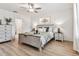 The bedroom features stylish furnishings, a ceiling fan, and a neutral color palette for a restful ambiance at 22229 Storybook Cabin Way, Land O Lakes, FL 34637