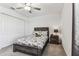 This cozy bedroom offers a stylish bed and a comfortable nightstand with a lamp for relaxing evenings at 22229 Storybook Cabin Way, Land O Lakes, FL 34637