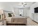 Bright and airy bedroom with window view and ceiling fan offers a peaceful retreat with modern décor at 22229 Storybook Cabin Way, Land O Lakes, FL 34637